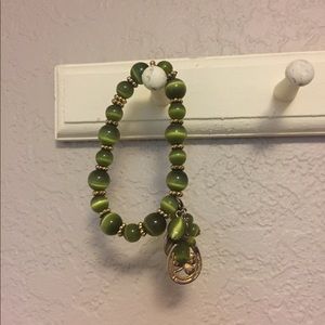 Green elastic bracelet with charms